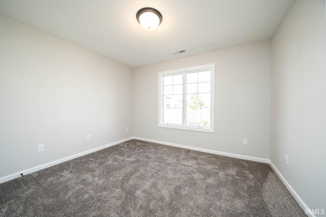 empty room with dark carpet