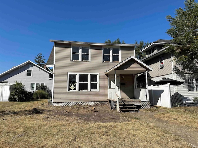 view of front property featuring a front lawn and covered porch