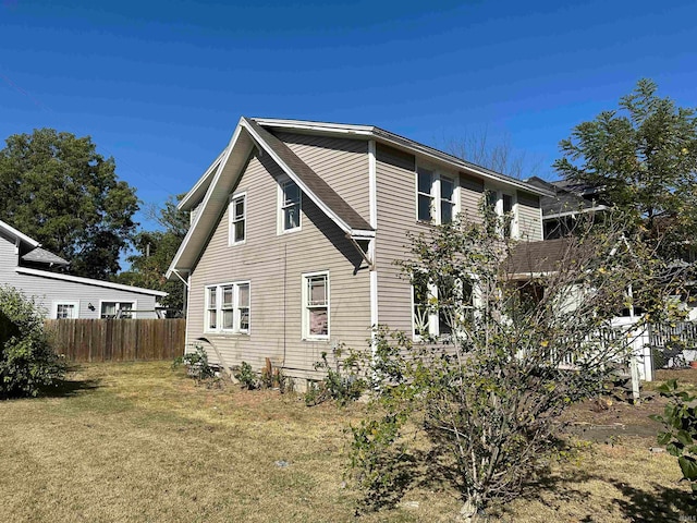 view of side of property with a lawn