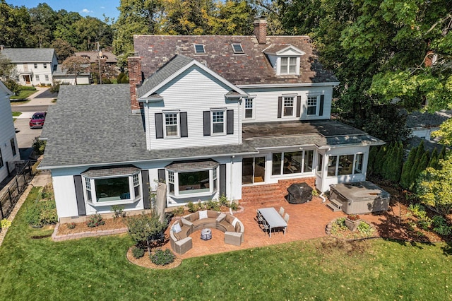 back of property featuring an outdoor living space with a fire pit, a yard, and a patio