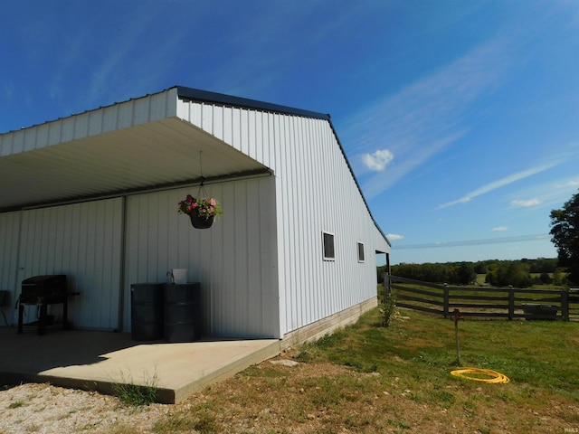 view of outdoor structure featuring a yard and a rural view