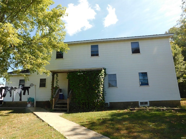 back of house with a lawn