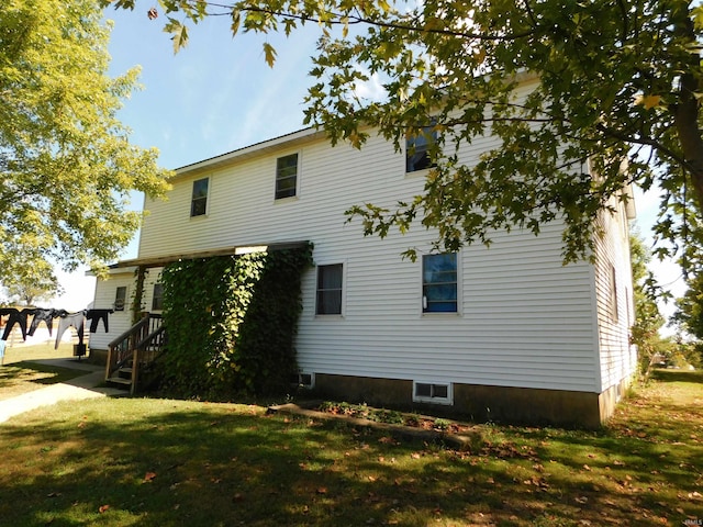 rear view of property with a lawn