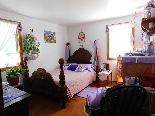 bedroom with dark hardwood / wood-style flooring