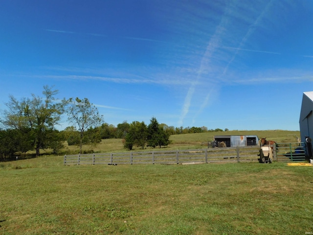 view of yard featuring a rural view and an outbuilding