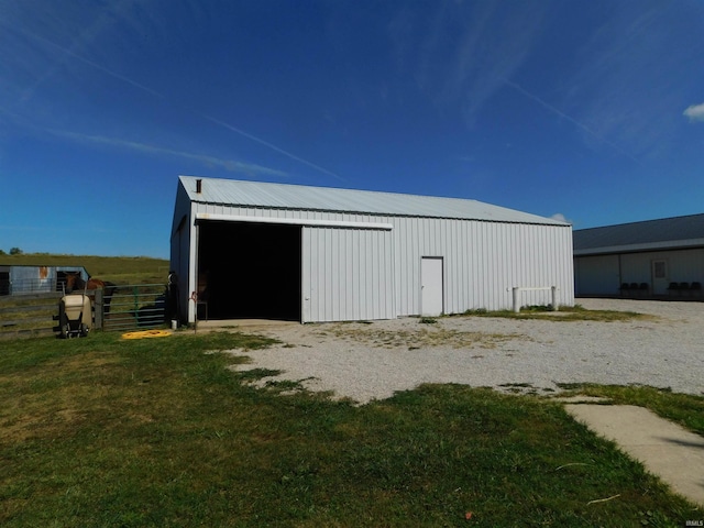 view of outbuilding with a yard