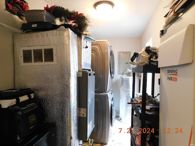 utility room featuring stacked washer / dryer