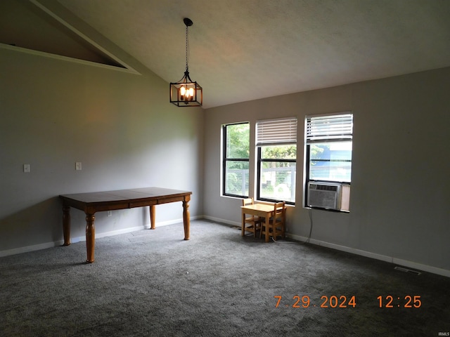 spare room featuring carpet, cooling unit, vaulted ceiling, and a notable chandelier