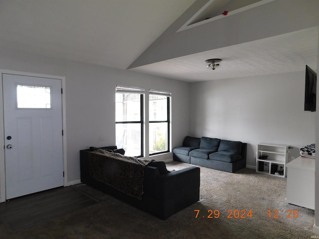 carpeted living room with vaulted ceiling