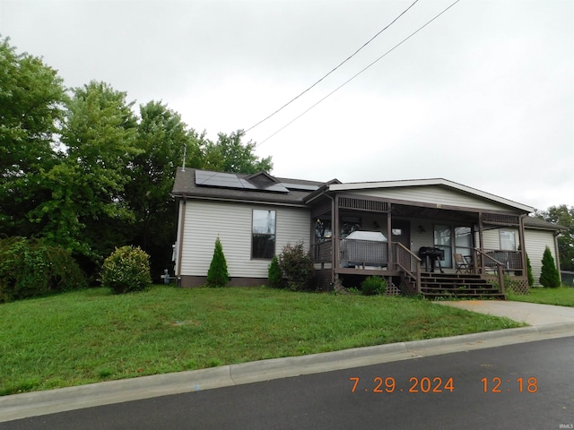 view of front of house with a front lawn and covered porch