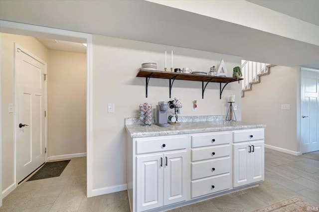 interior space with white cabinets and light wood-type flooring