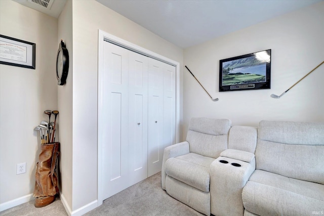 living area featuring light carpet