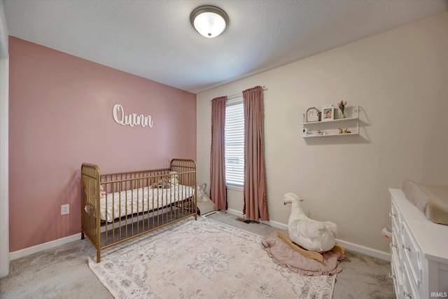 bedroom featuring a crib and light colored carpet