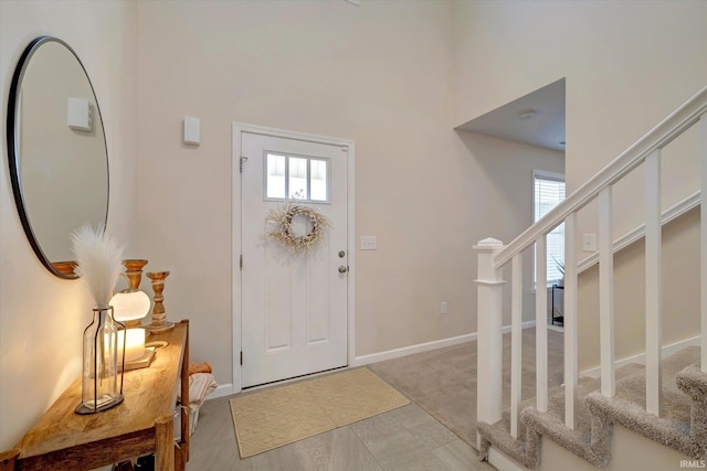 view of carpeted foyer entrance