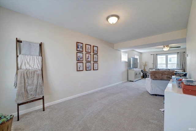 living room featuring ceiling fan and light colored carpet