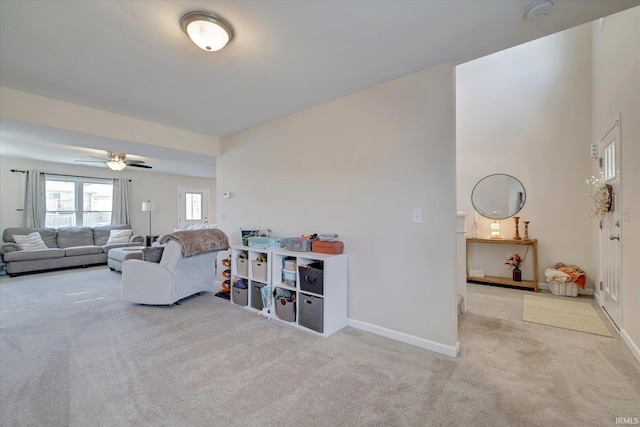 living room featuring ceiling fan and light colored carpet