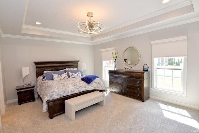 carpeted bedroom featuring a tray ceiling, a chandelier, and crown molding