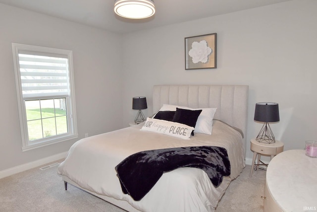 carpeted bedroom with baseboards and visible vents