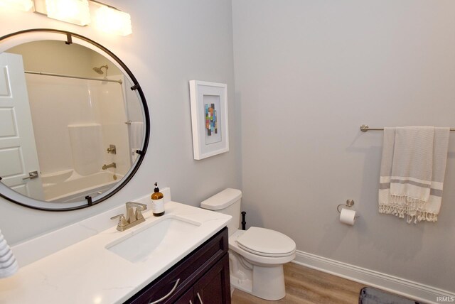 full bathroom with shower / bathtub combination, hardwood / wood-style floors, vanity, and toilet