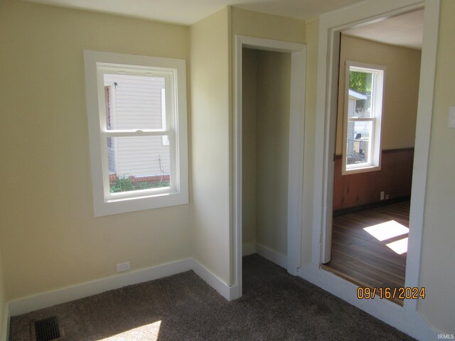 interior space featuring dark colored carpet