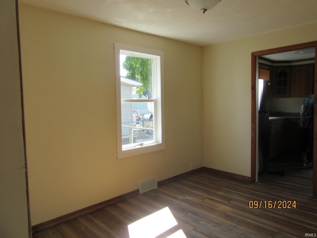 empty room with dark hardwood / wood-style flooring