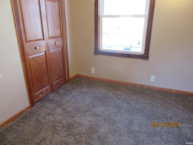 unfurnished bedroom featuring carpet flooring and a closet