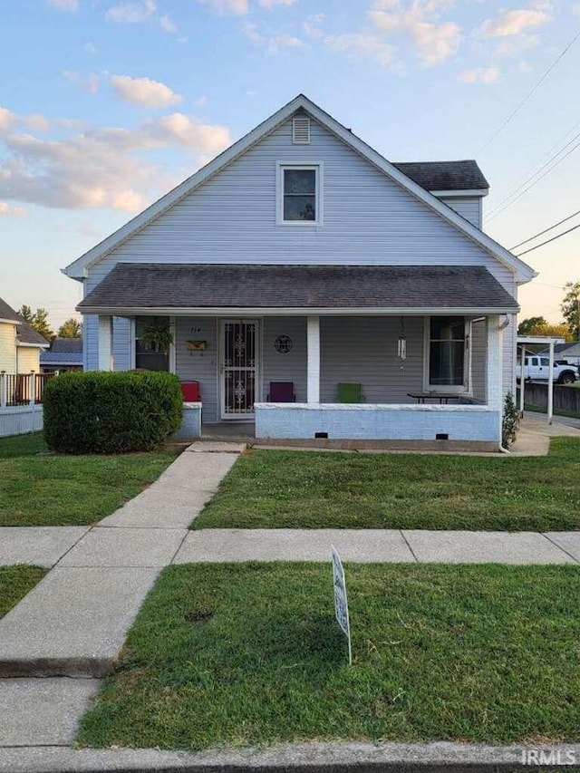 view of front of home featuring a yard and a porch