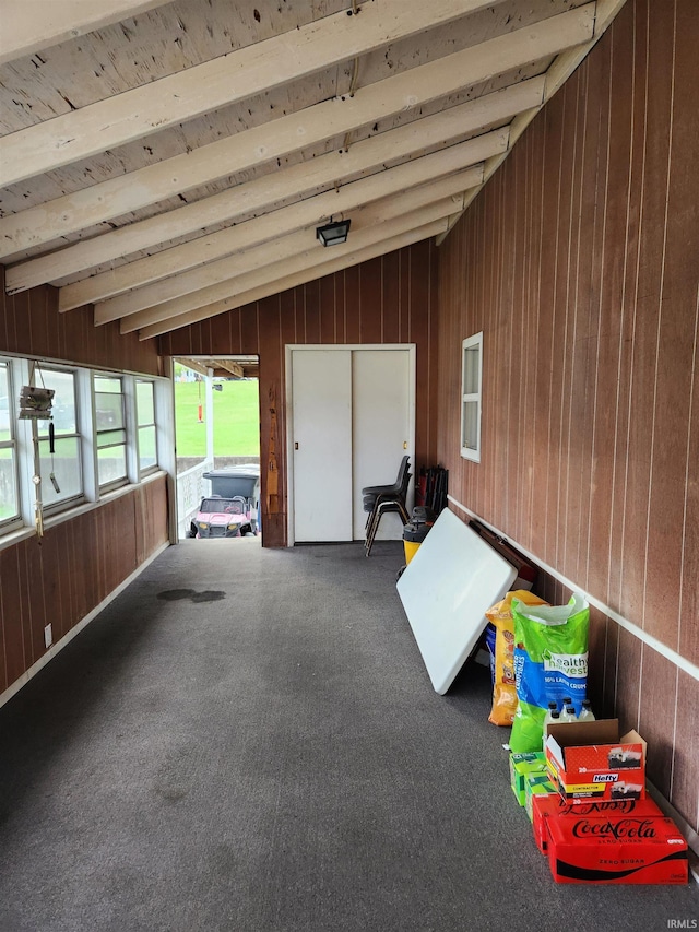 unfurnished sunroom featuring lofted ceiling with beams