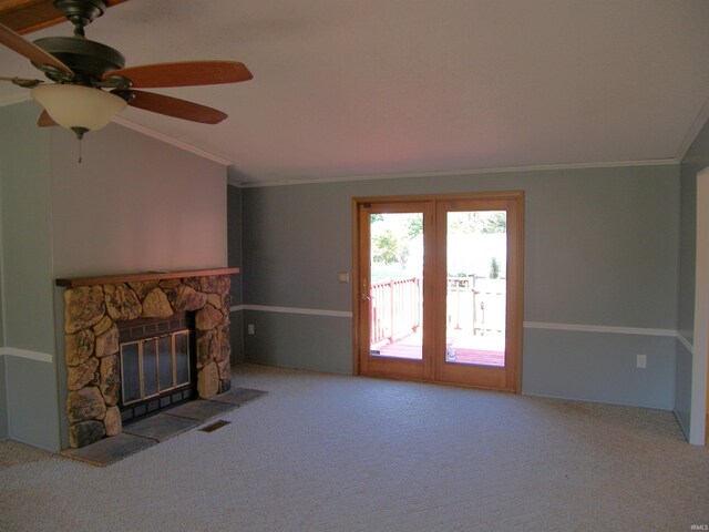 unfurnished living room with a fireplace, lofted ceiling, ceiling fan, ornamental molding, and light carpet