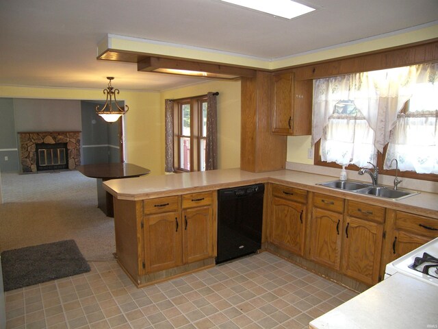 kitchen featuring black dishwasher, sink, kitchen peninsula, decorative light fixtures, and a stone fireplace