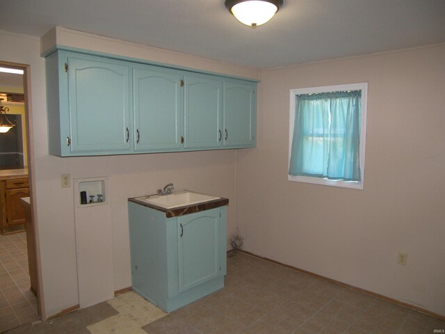 clothes washing area featuring washer hookup, cabinets, and sink