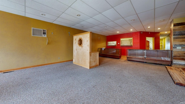 unfurnished living room featuring carpet floors and a paneled ceiling