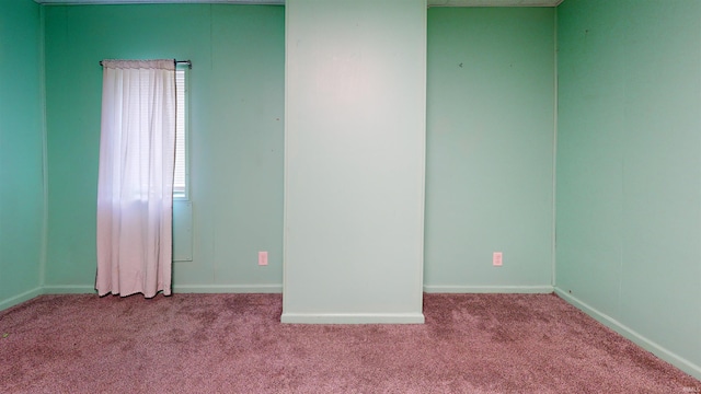 unfurnished room featuring light colored carpet