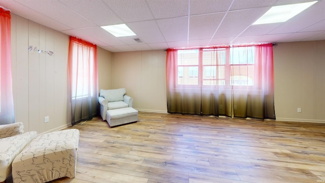 sitting room featuring a paneled ceiling and light hardwood / wood-style floors