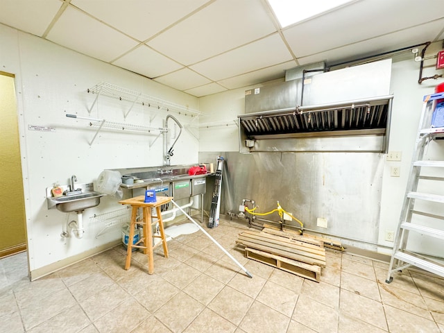 interior space featuring a drop ceiling and sink