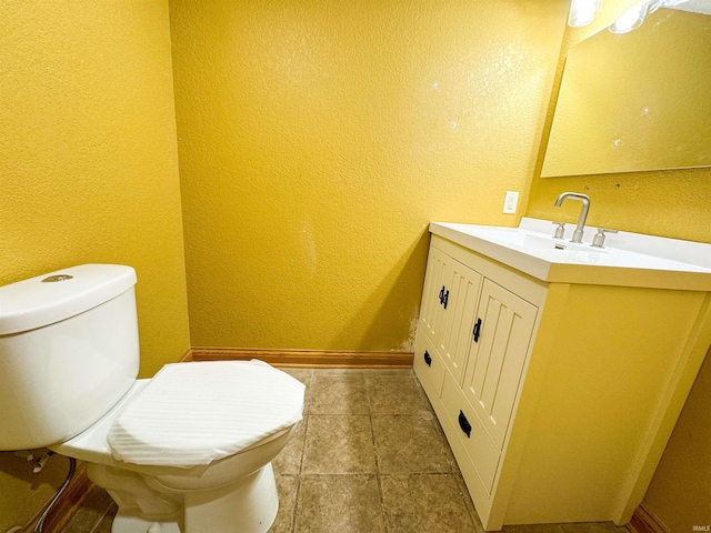 bathroom with vanity, toilet, and tile patterned floors