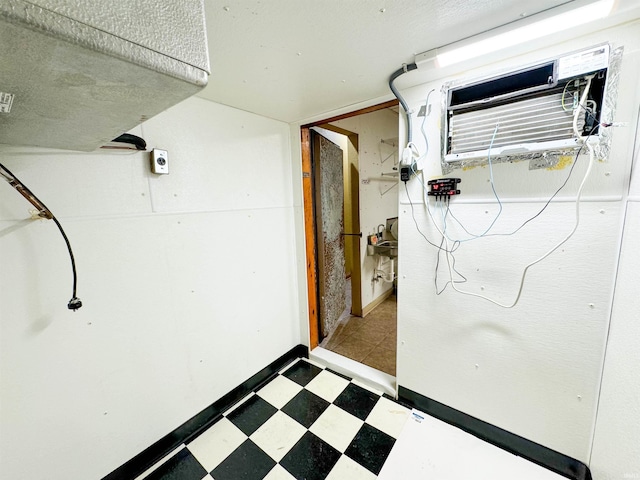 basement featuring an AC wall unit