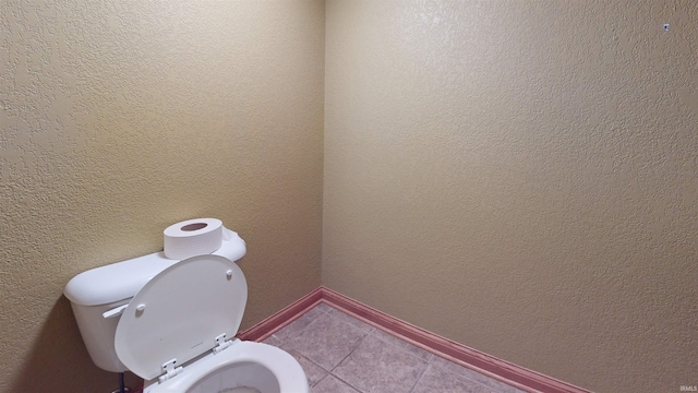 bathroom with tile patterned flooring and toilet