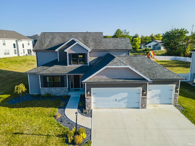 craftsman-style home with a garage and a front lawn