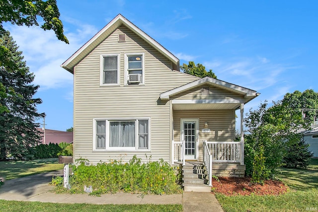 view of front of property featuring a front lawn and covered porch