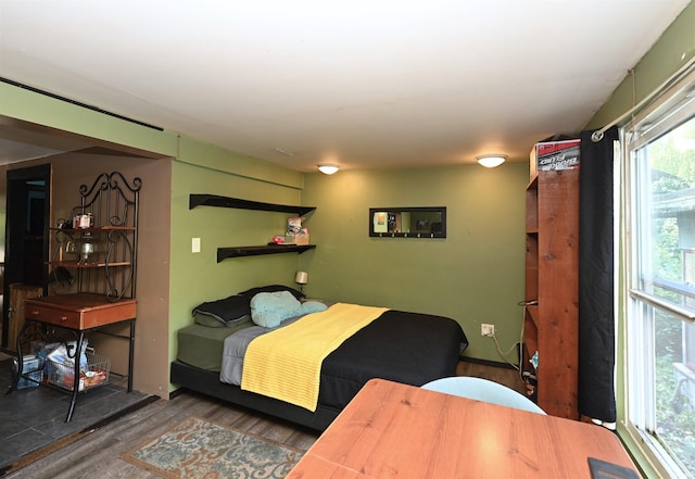 bedroom with dark hardwood / wood-style flooring