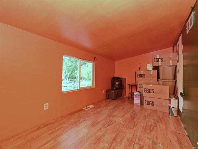 interior space featuring light hardwood / wood-style flooring and vaulted ceiling