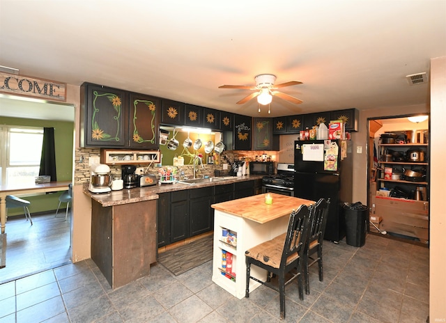 kitchen with black appliances, ceiling fan, tile patterned floors, and sink