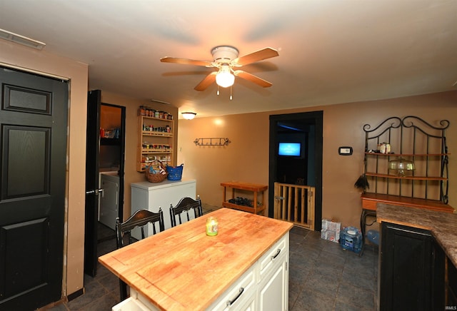 tiled dining space featuring ceiling fan