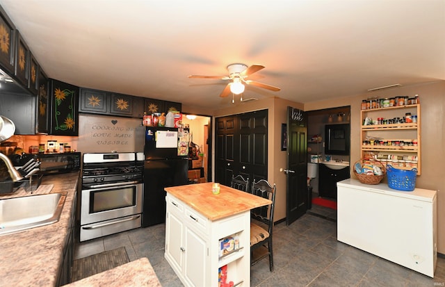 kitchen with sink, white cabinetry, butcher block counters, stainless steel appliances, and ceiling fan