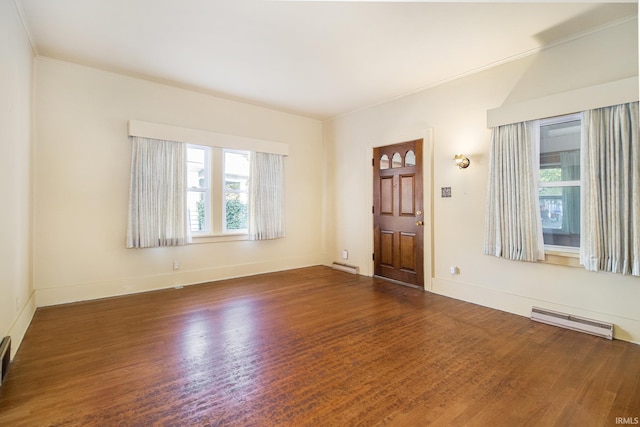 interior space featuring ornamental molding, dark hardwood / wood-style flooring, and a baseboard heating unit