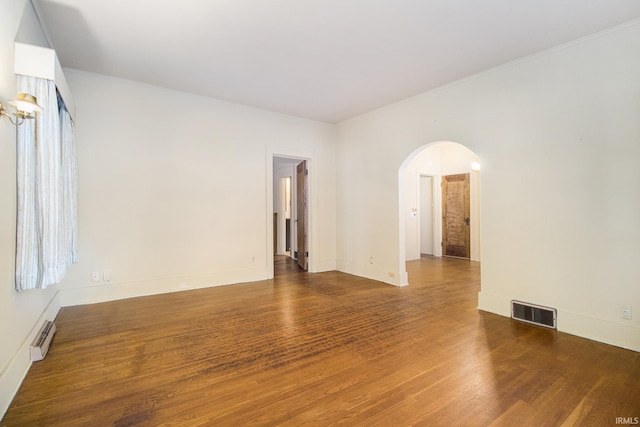 unfurnished room featuring dark hardwood / wood-style floors and a baseboard radiator