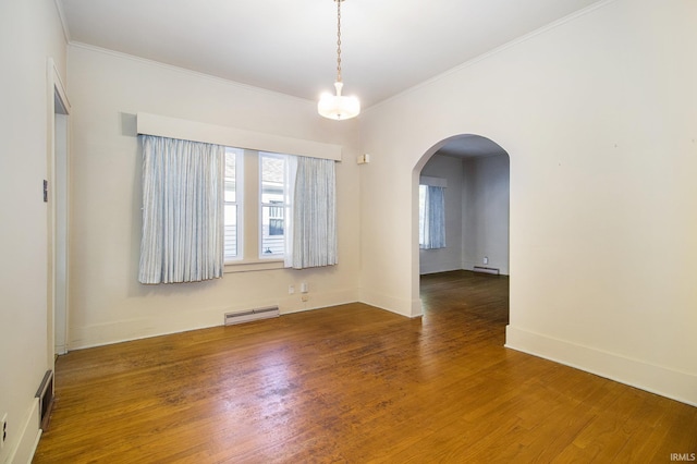 unfurnished room with ornamental molding, baseboard heating, and dark hardwood / wood-style floors