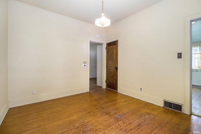 unfurnished room with wood-type flooring and crown molding