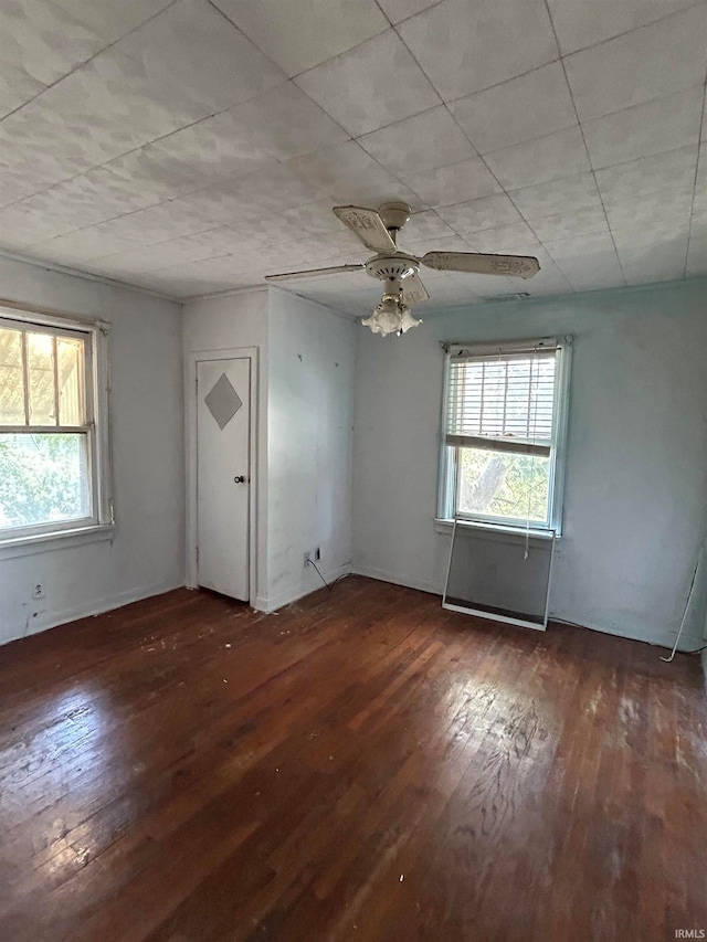 unfurnished room featuring ceiling fan and dark hardwood / wood-style floors